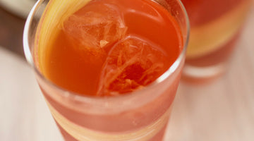 Garden Party NA cocktail in collins with rhubarb ribbon.