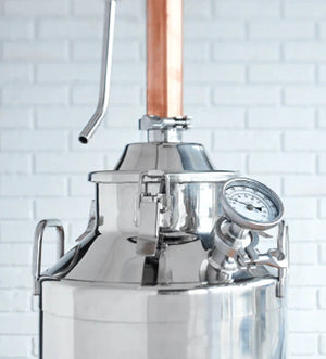 Close-up of the top of a stainless steel still with a copper column.