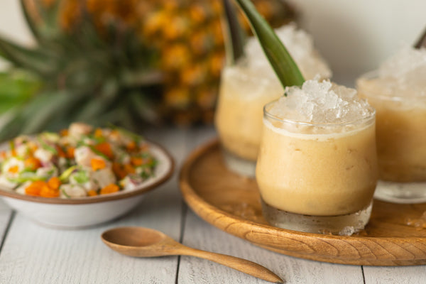 Close-up of a trio of glasses containing non-alcoholic cocktails next to a bowl of ceviche.