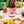 Load image into Gallery viewer, A close-up of a marble coffee table that holds a wine and cheese platter, several glasses of non-alcoholic mixed drinks, and a bottle containing a non-alcoholic cocktail.