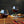 Load image into Gallery viewer, Close-up of two wine glasses containing a non-alcoholic cocktail that rest on a wood dining table next to plates of food.